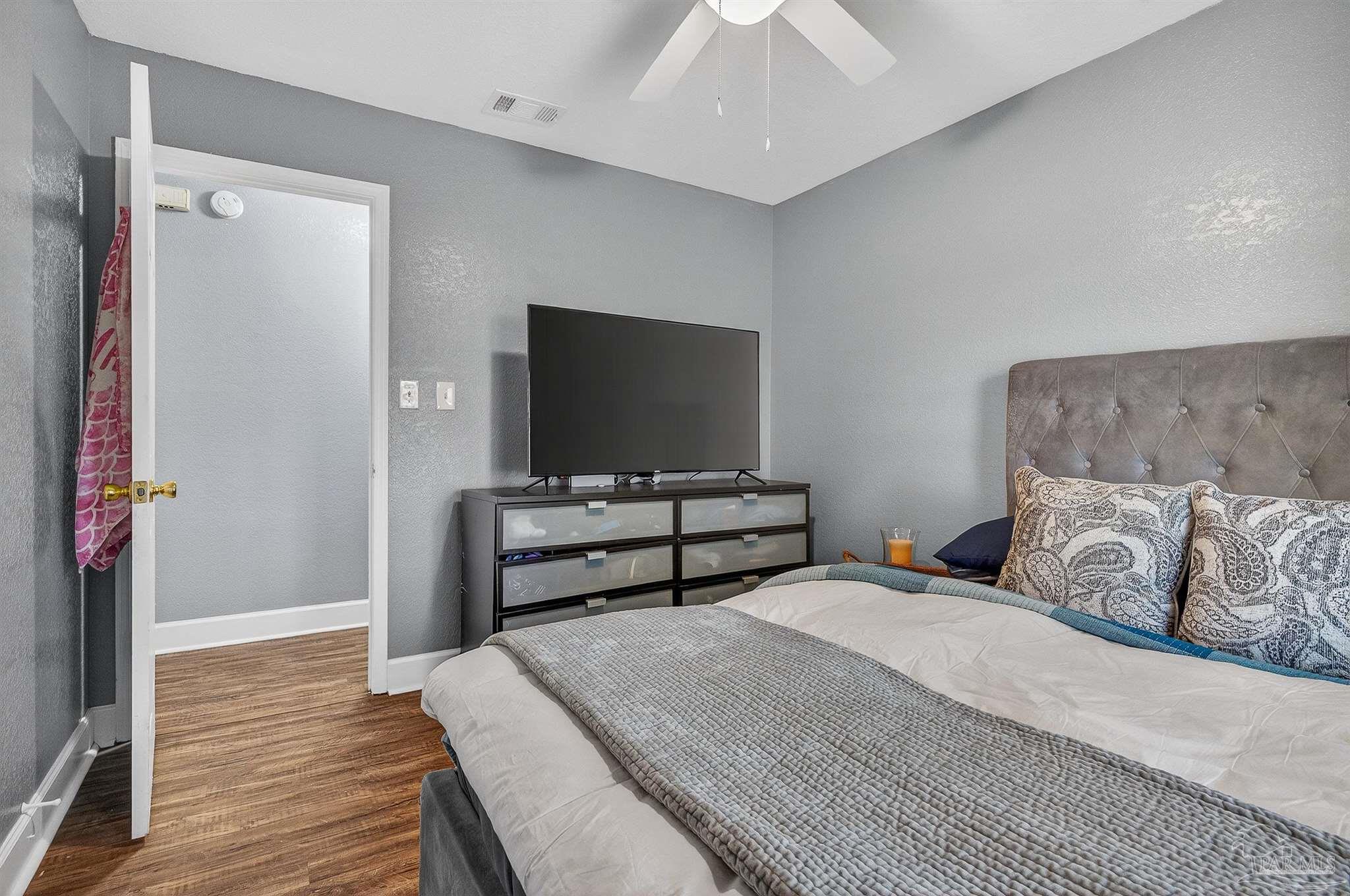 4807 Jennifer Lane Pace, FL 32571 - Photo 28 of 49 a bedroom with a bed and a flat screen tv