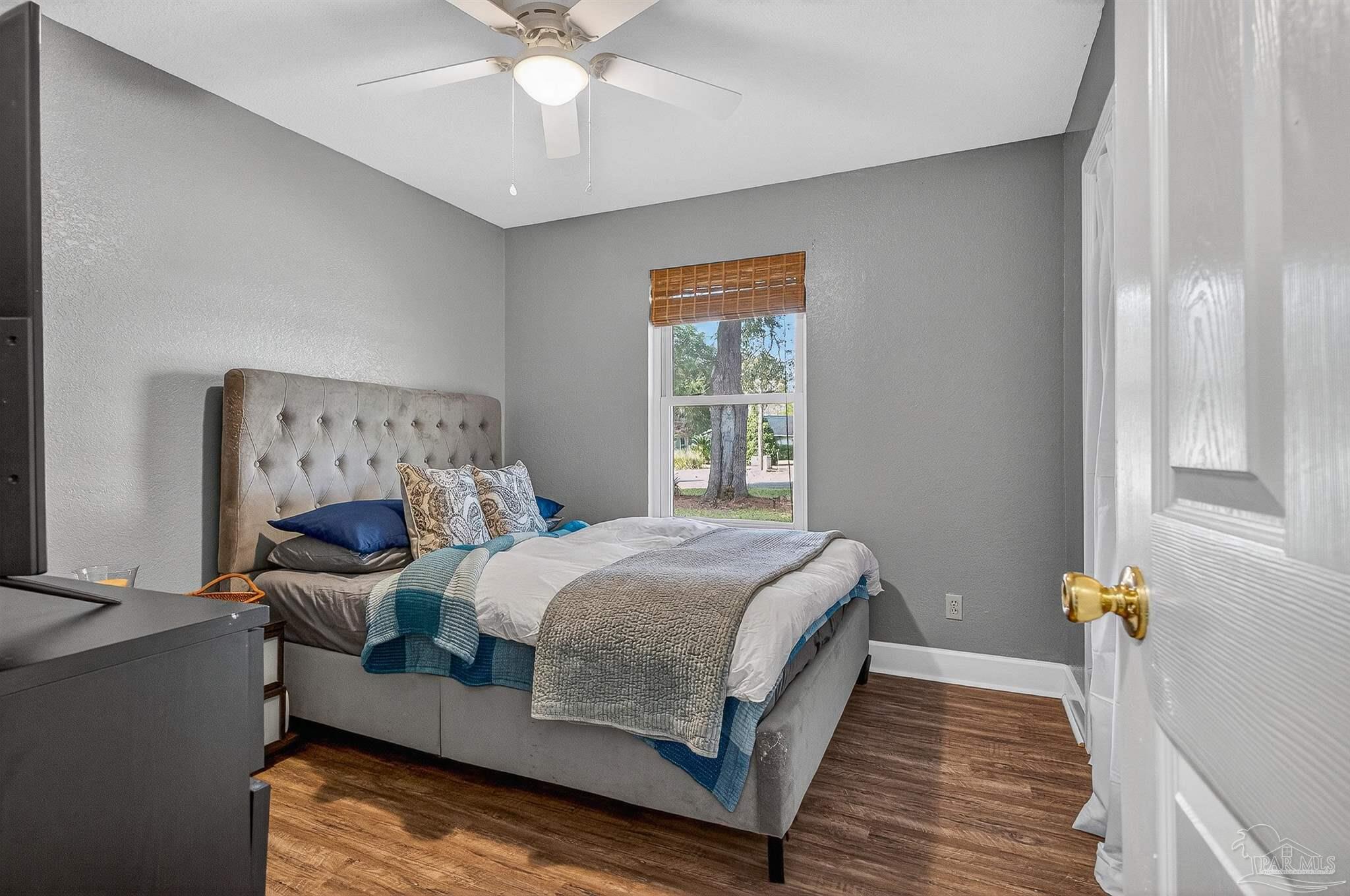 4807 Jennifer Lane Pace, FL 32571 - Photo 29 of 49 a bedroom with a bed and wooden floor