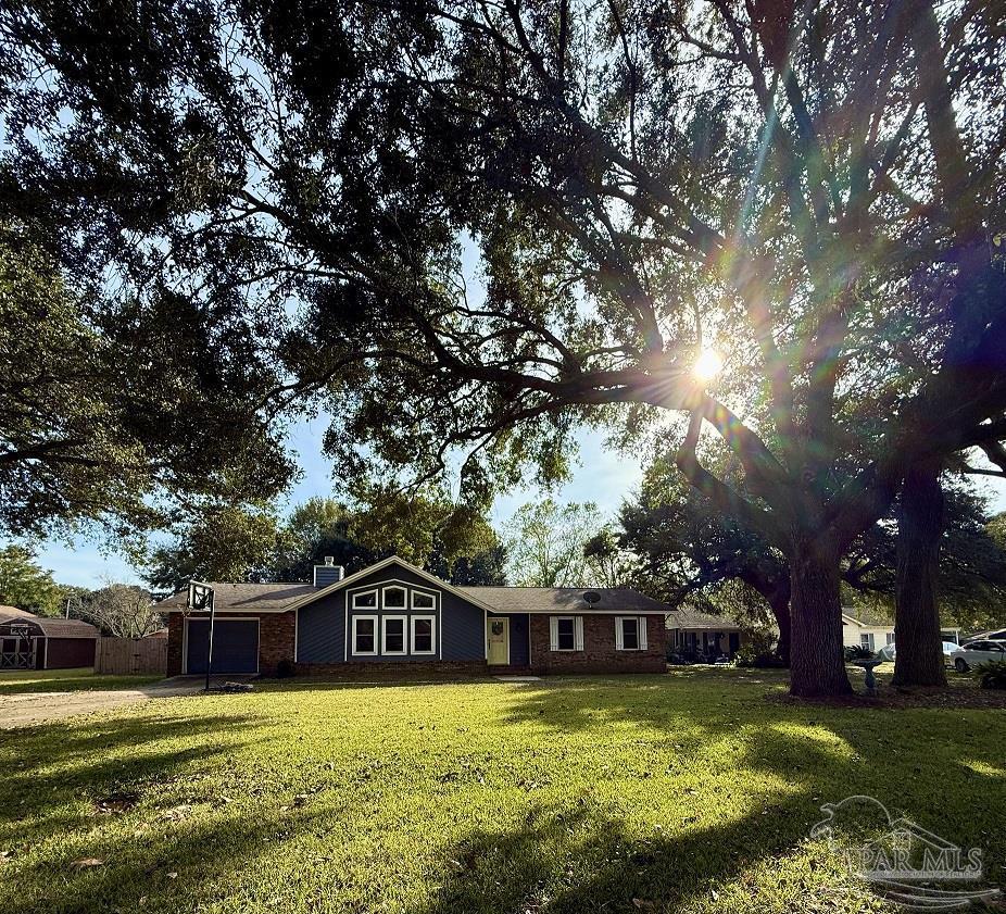 4807 Jennifer Lane Pace, FL 32571 - Photo 3 of 49 a view of a house with swimming pool and a yard