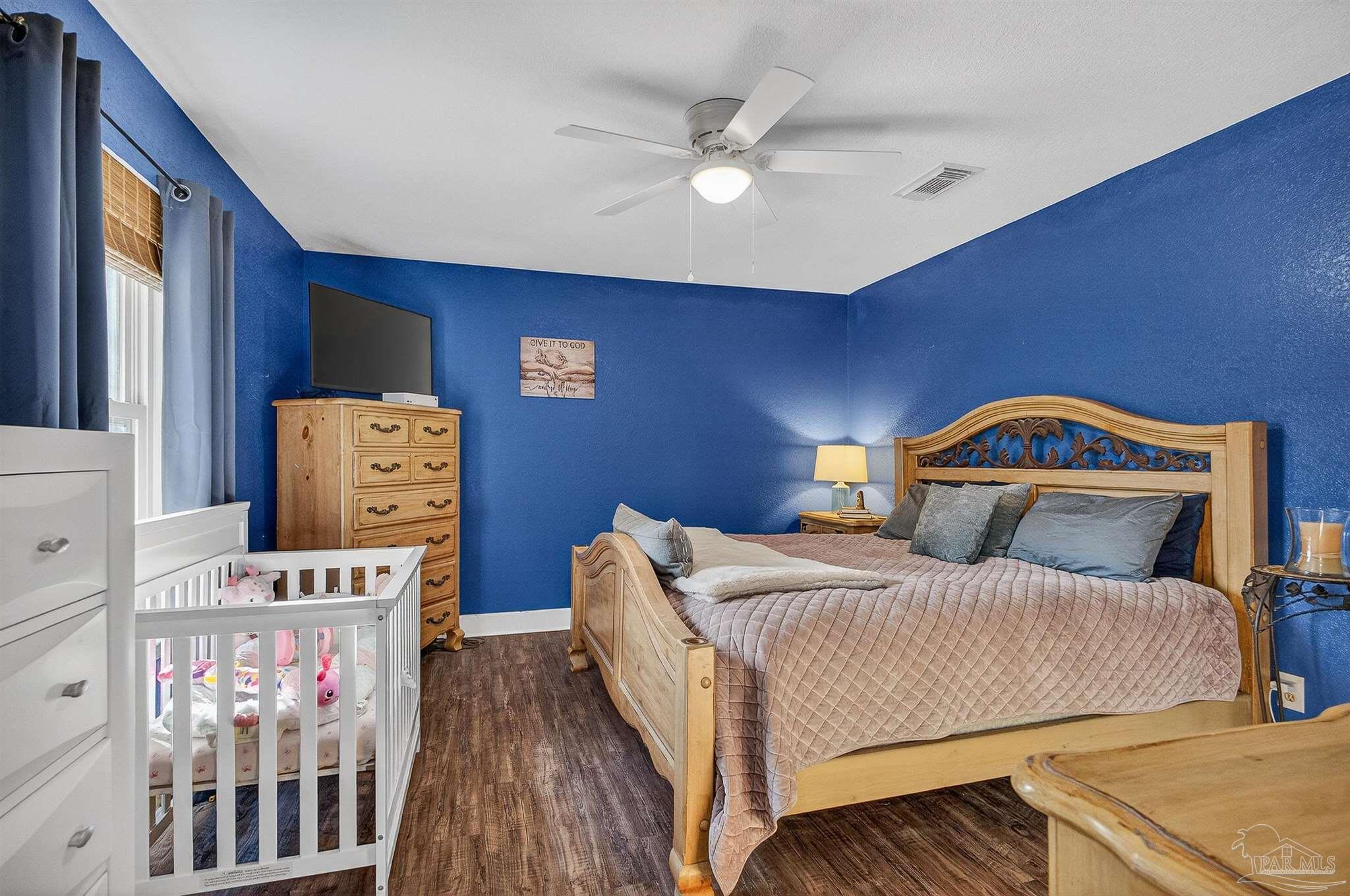 4807 Jennifer Lane Pace, FL 32571 - Photo 32 of 49 a bedroom with a bed and a tv