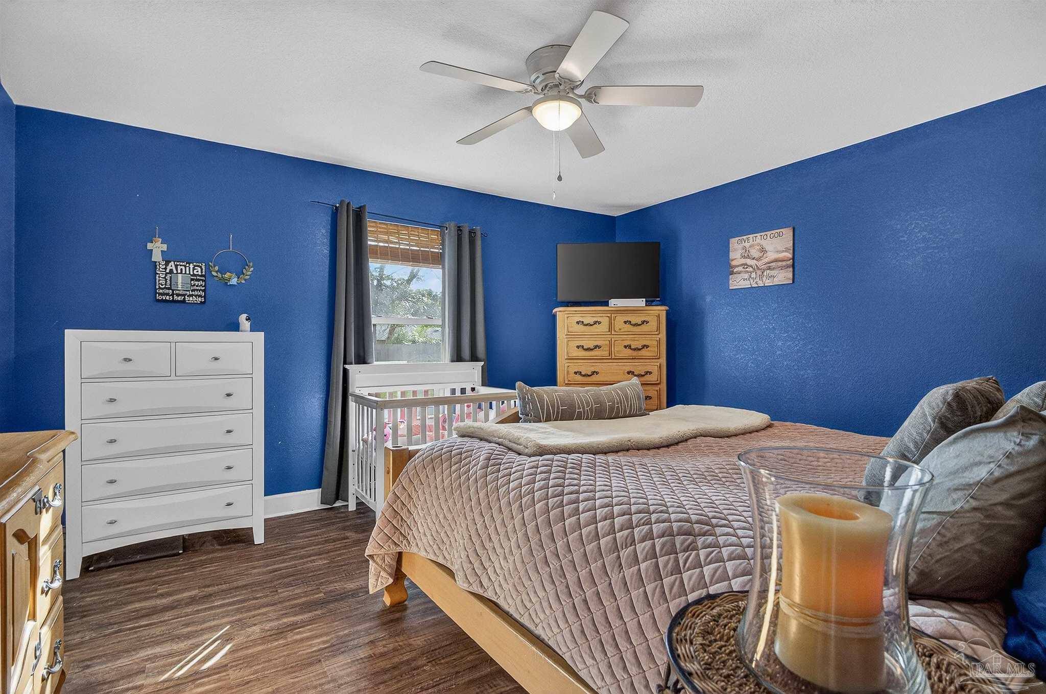 4807 Jennifer Lane Pace, FL 32571 - Photo 33 of 49 a bedroom with a bed and a dresser