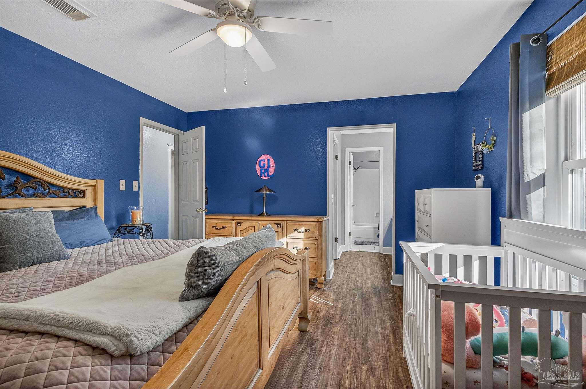 4807 Jennifer Lane Pace, FL 32571 - Photo 34 of 49 a bedroom with furniture and wooden floor