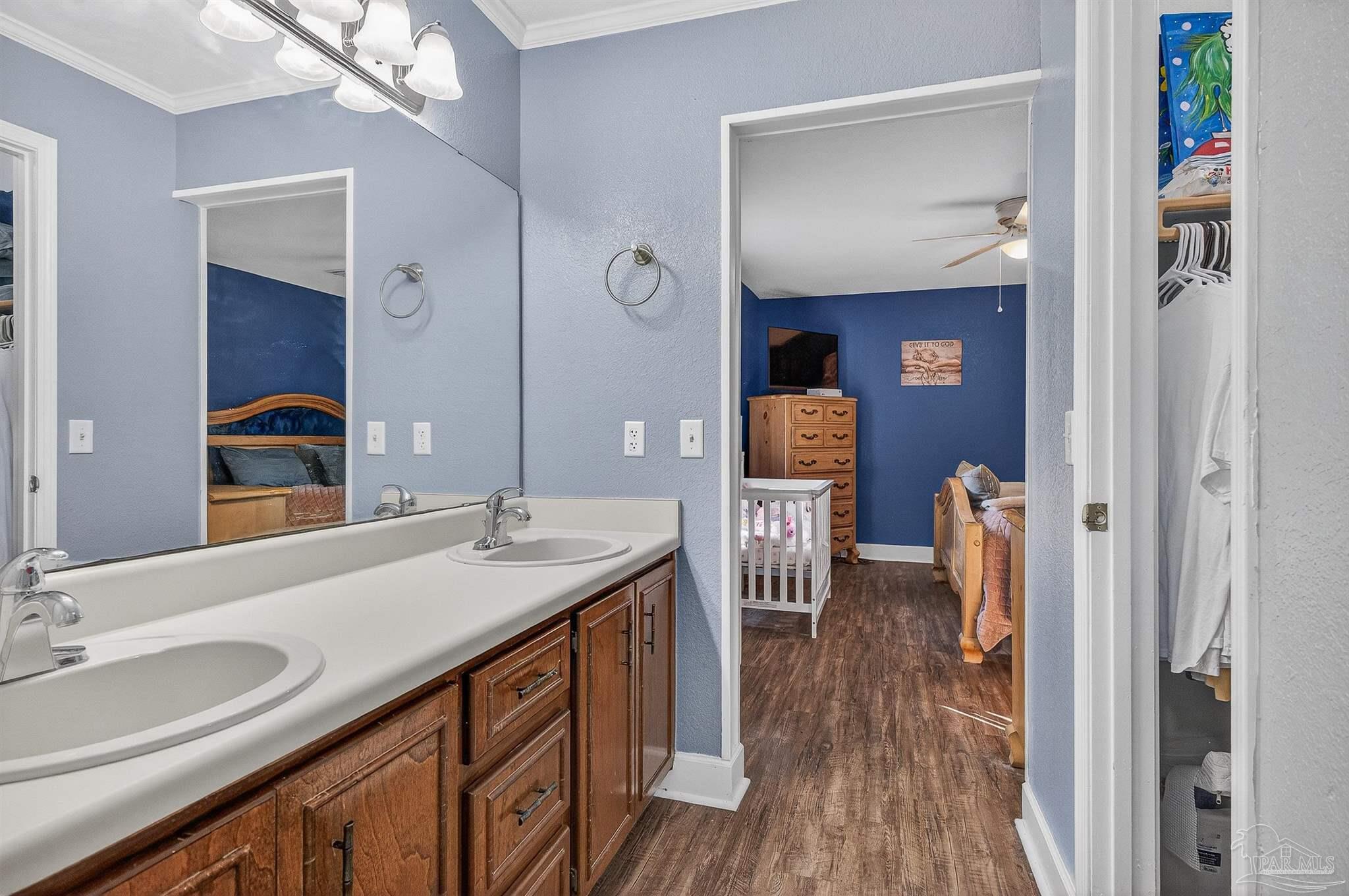 4807 Jennifer Lane Pace, FL 32571 - Photo 36 of 49 a bathroom with a sink a mirror and a toilet