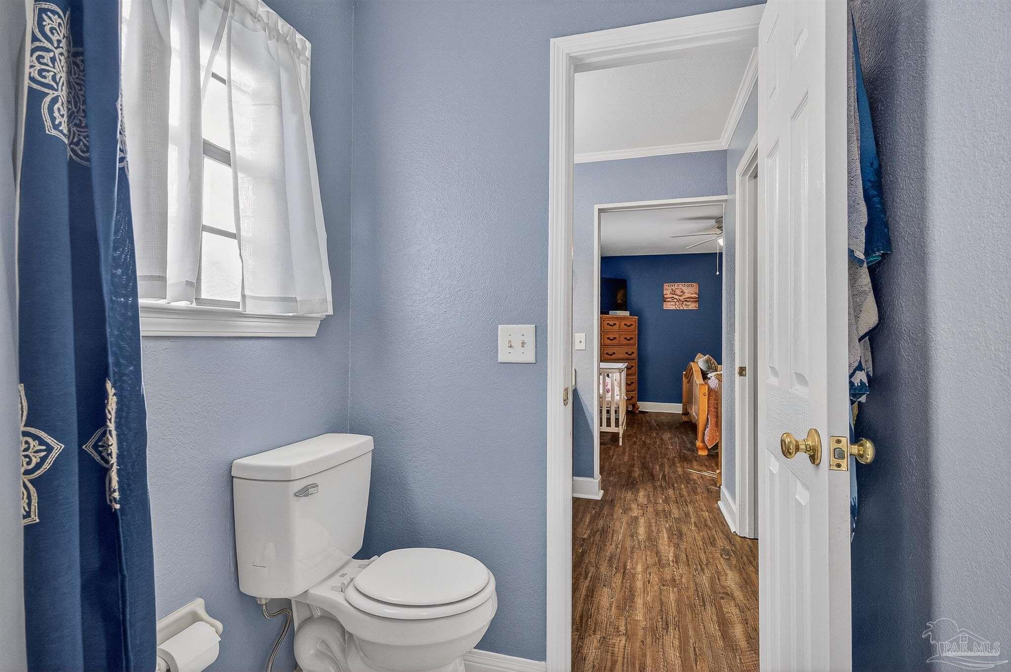 4807 Jennifer Lane Pace, FL 32571 - Photo 37 of 49 a bathroom with a toilet sink and a window