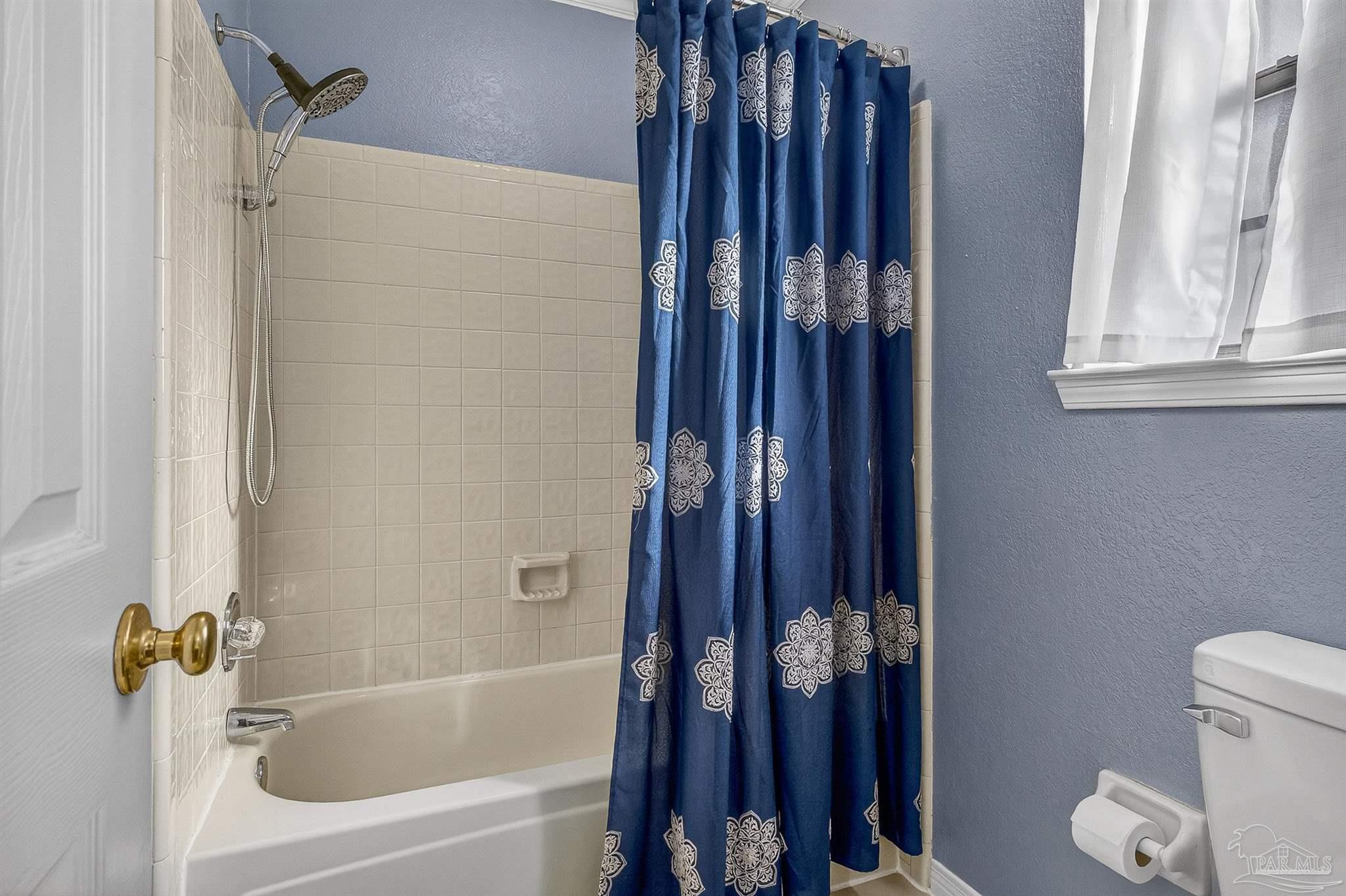 4807 Jennifer Lane Pace, FL 32571 - Photo 38 of 49 a bathroom with a bathtub and a shower
