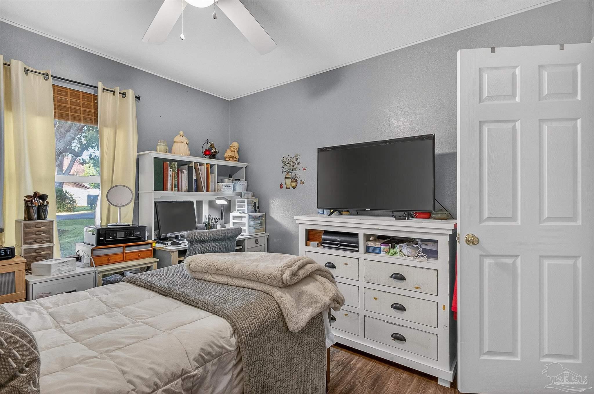 4807 Jennifer Lane Pace, FL 32571 - Photo 39 of 49 a bedroom with furniture and a flat screen tv