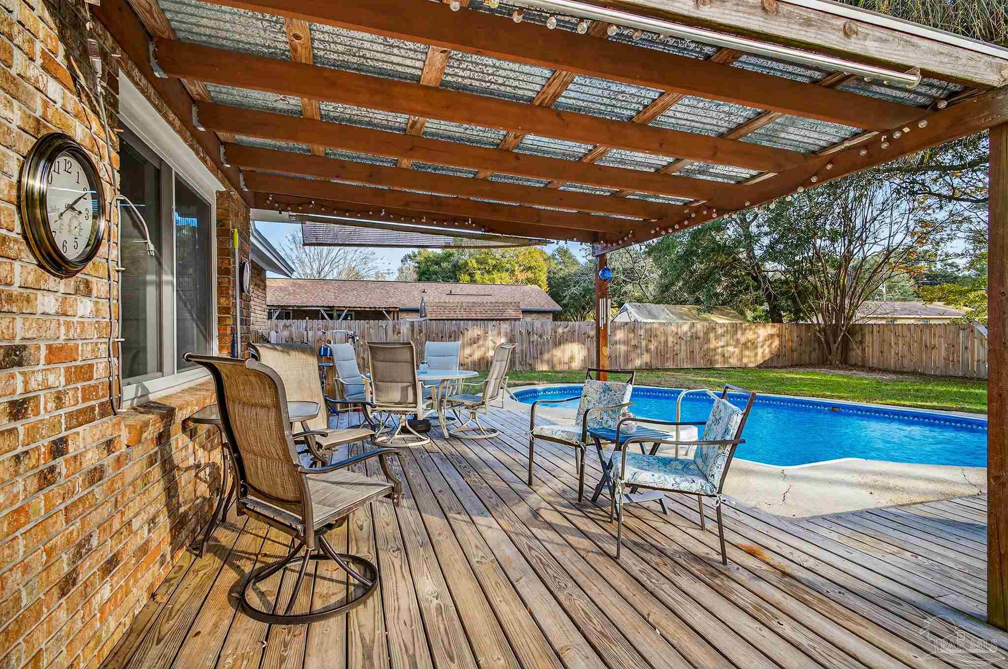 4807 Jennifer Lane Pace, FL 32571 - Photo 4 of 49 a view of a chairs and tables in the patio