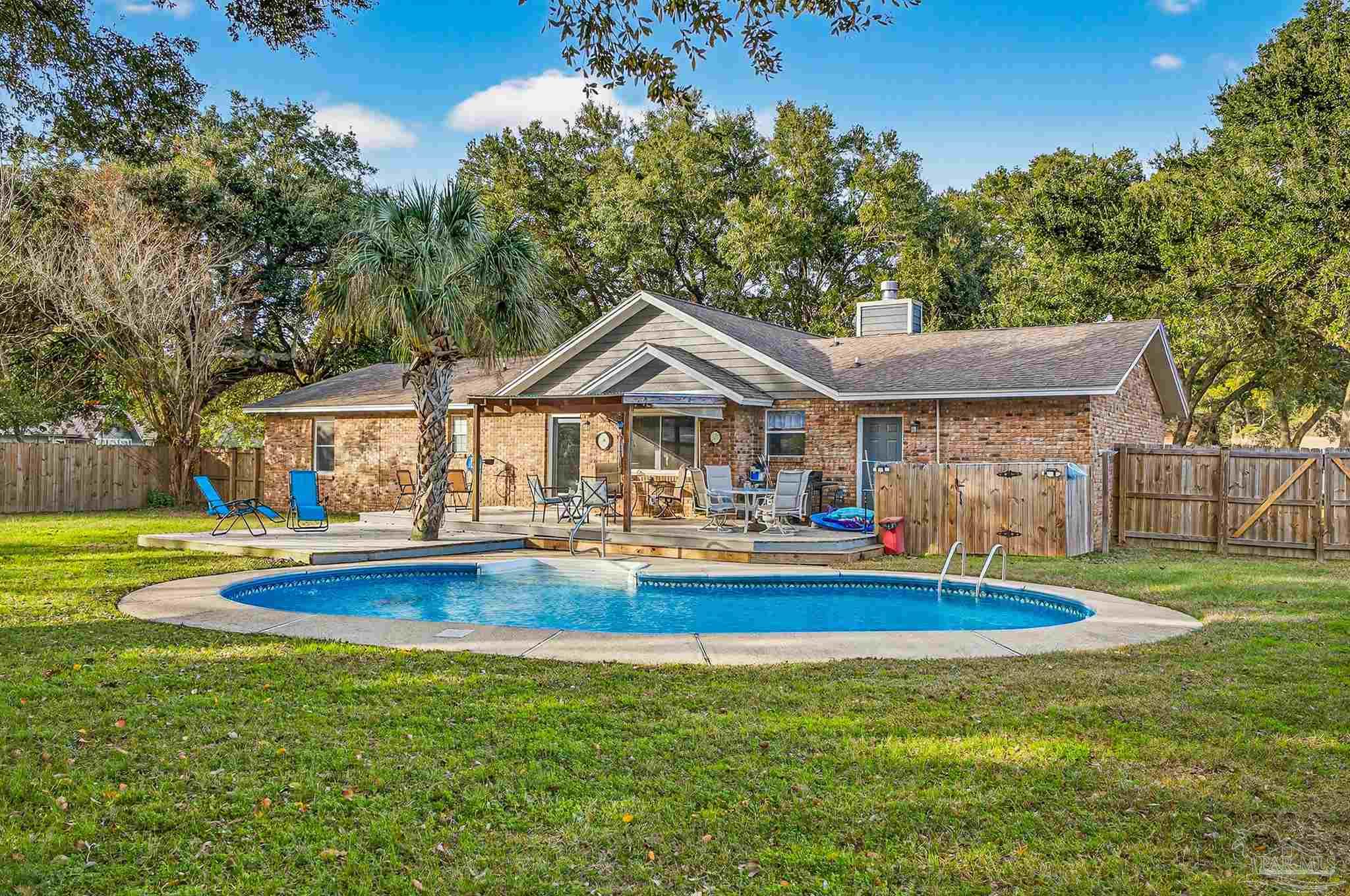 4807 Jennifer Lane Pace, FL 32571 - Photo 43 of 49 a front view of house with outdoor space and yard