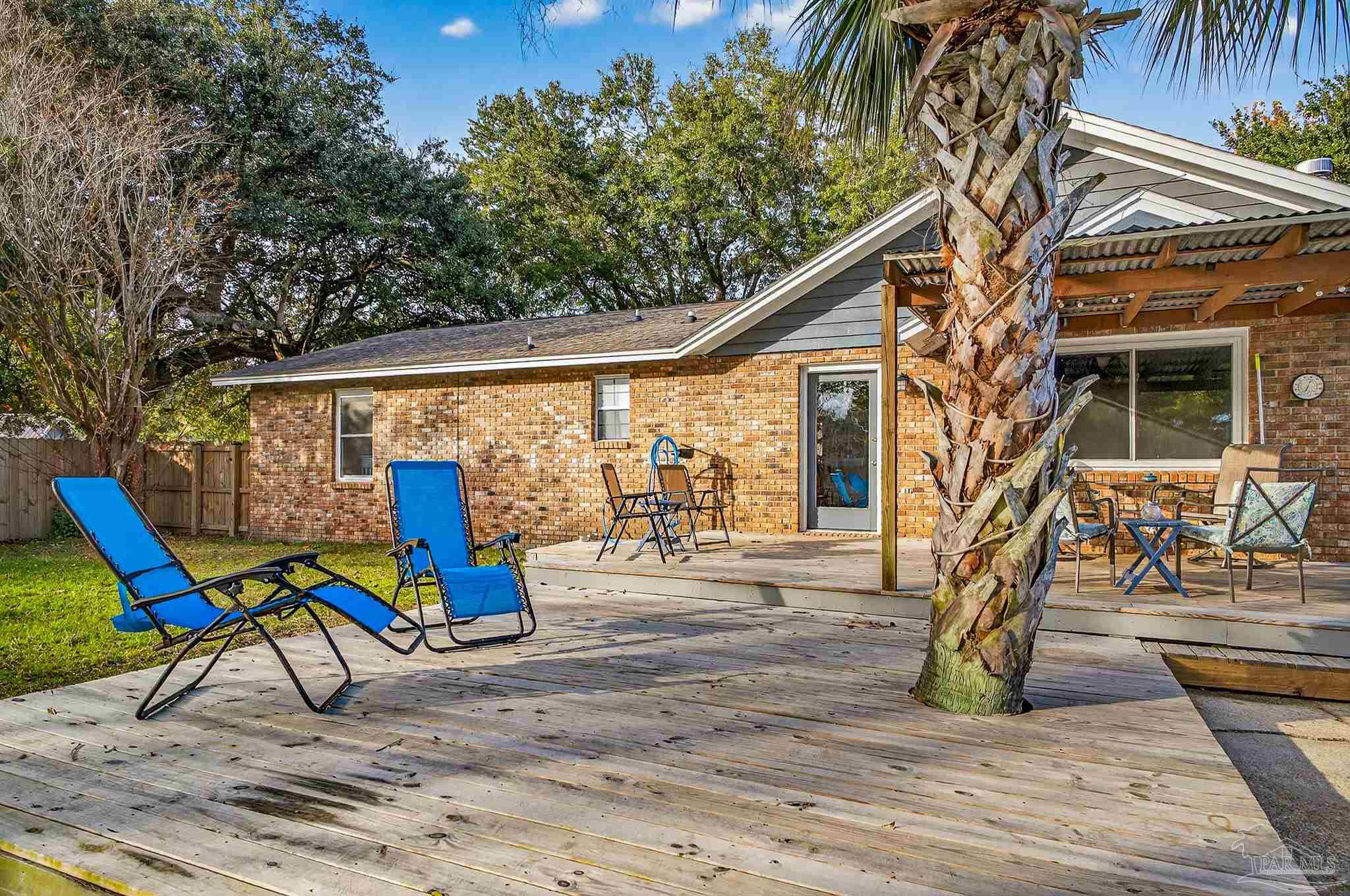 4807 Jennifer Lane Pace, FL 32571 - Photo 48 of 49 a backyard of a house with table and chairs