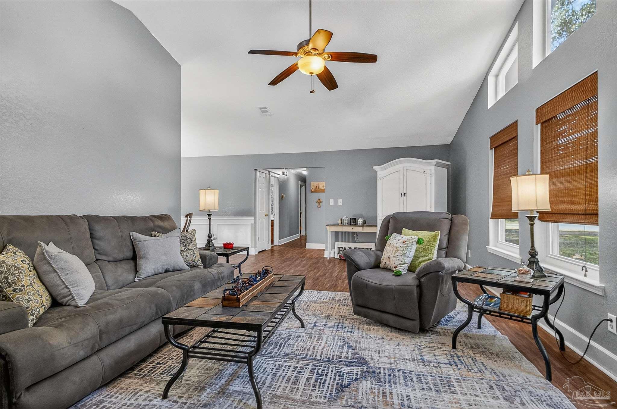 4807 Jennifer Lane Pace, FL 32571 - Photo 6 of 49 a living room with furniture ceiling fan and a window