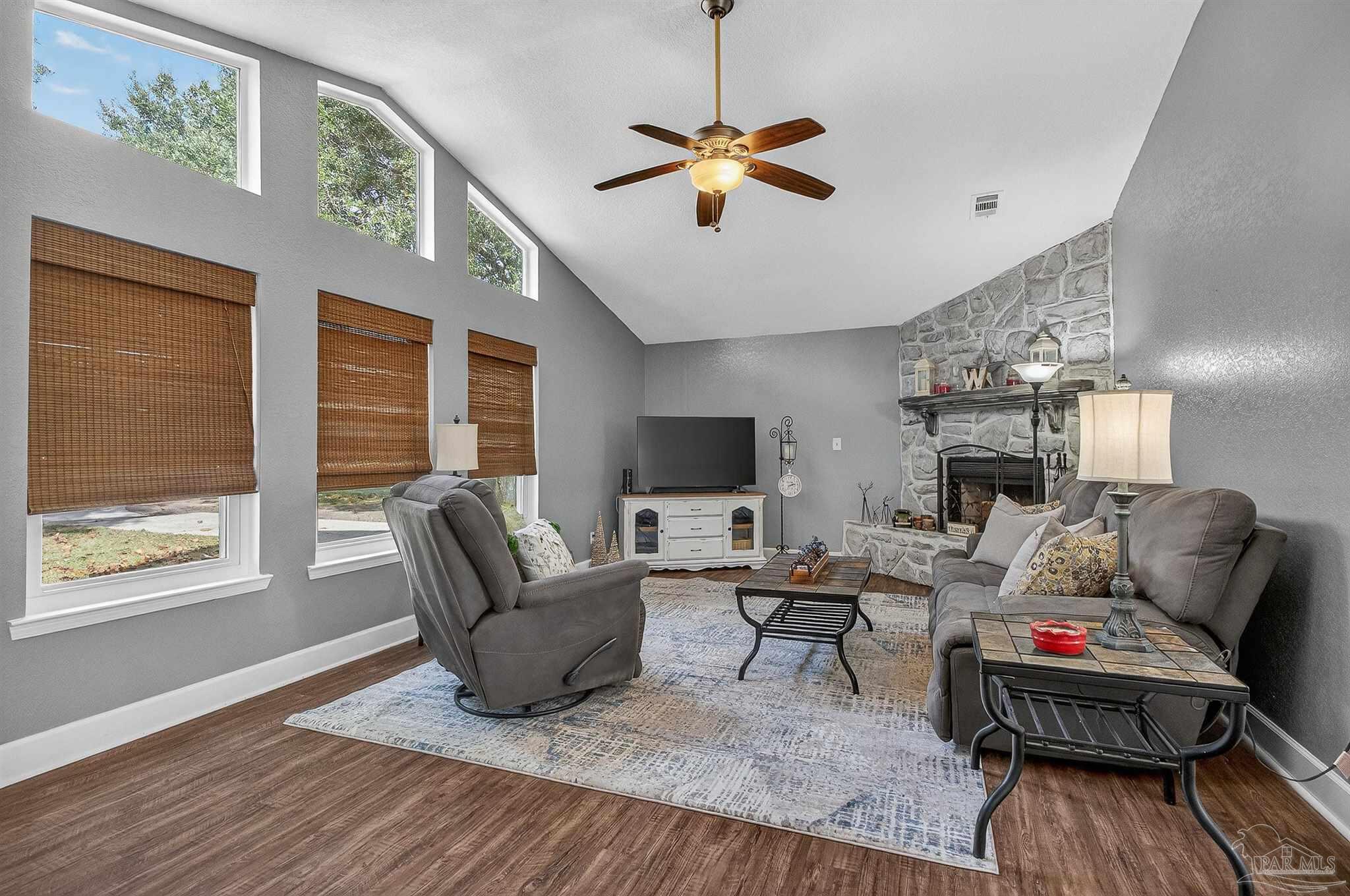 4807 Jennifer Lane Pace, FL 32571 - Photo 8 of 49 a living room with furniture a fireplace and a flat screen tv