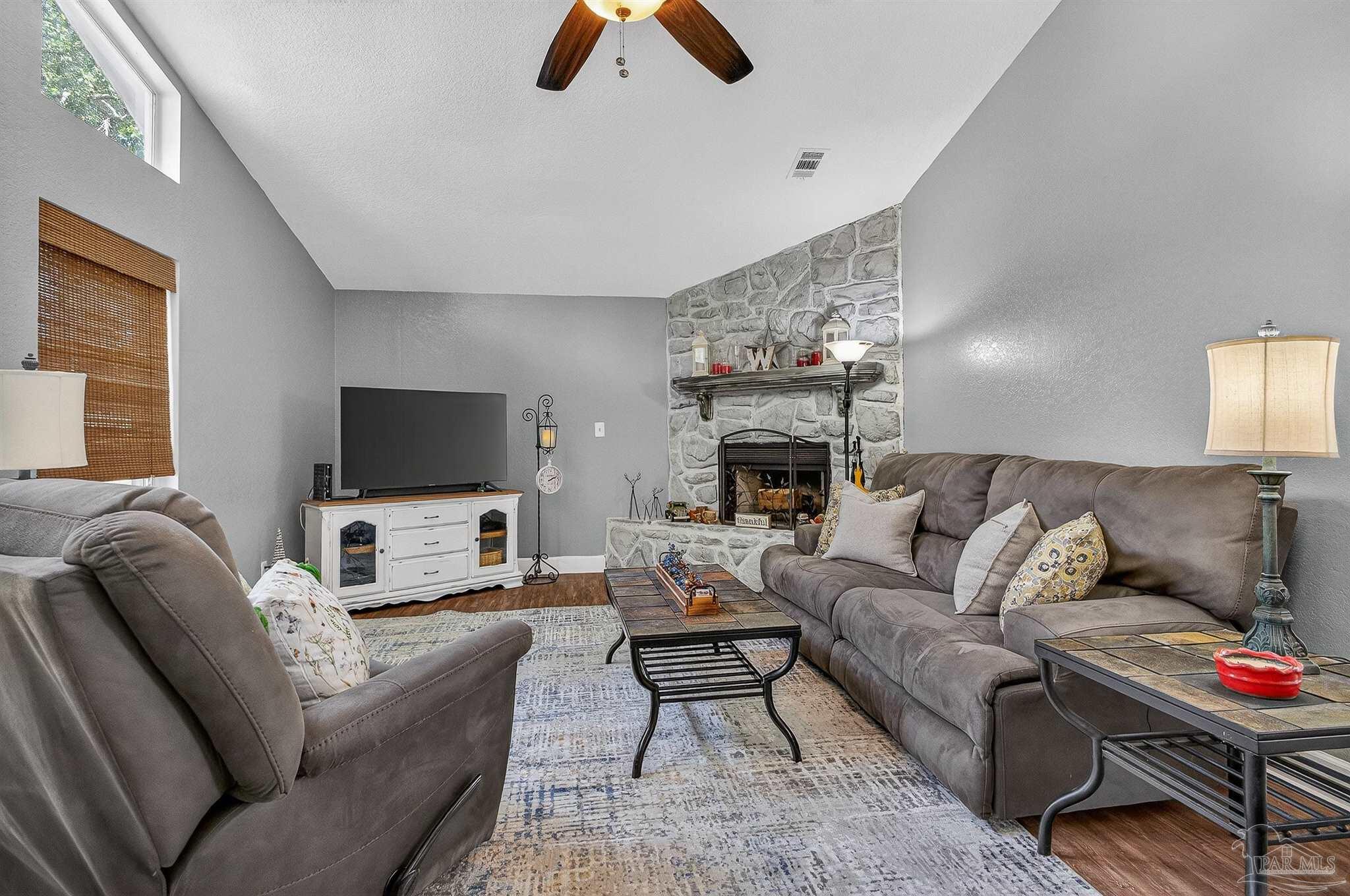 4807 Jennifer Lane Pace, FL 32571 - Photo 9 of 49 a living room with furniture and a flat screen tv