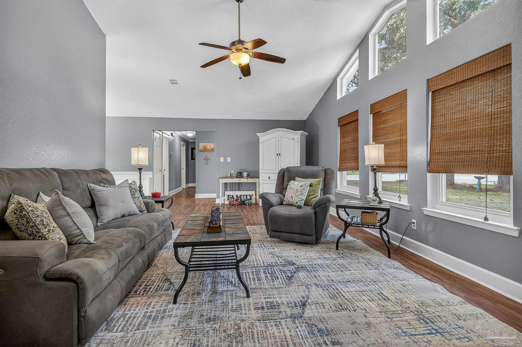4807 Jennifer Lane Pace, FL 32571 - Photo 10 of 49 a living room with furniture a ceiling fan and a window