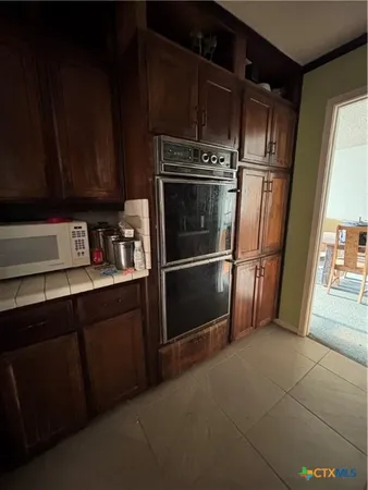 a kitchen with stainless steel appliances granite countertop a sink stove and cabinets