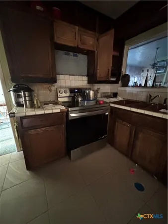 a kitchen with a sink appliances and cabinets