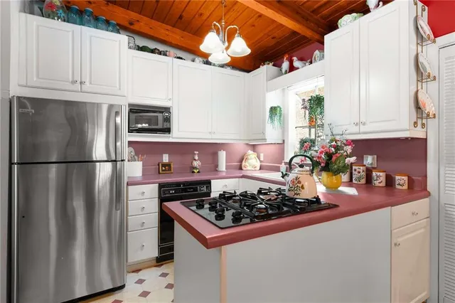 a kitchen with stainless steel appliances granite countertop a refrigerator stove and sink