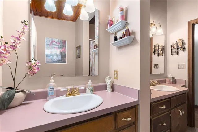 a bathroom with a sink vanity and a mirror