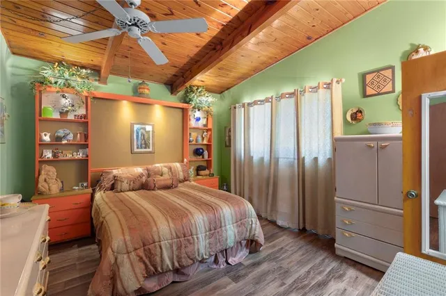 a bedroom with a bed next to a window