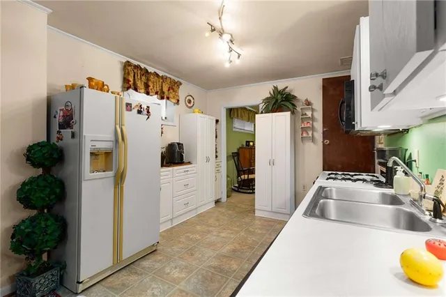 a kitchen with a refrigerator and a sink