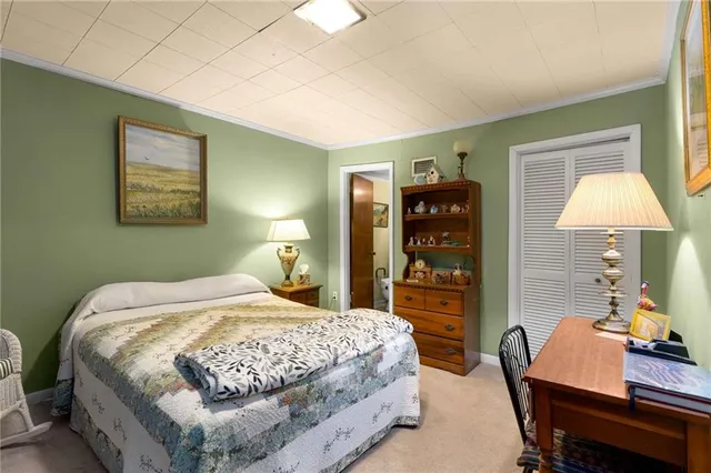 a bedroom with a bed and a lamp on table