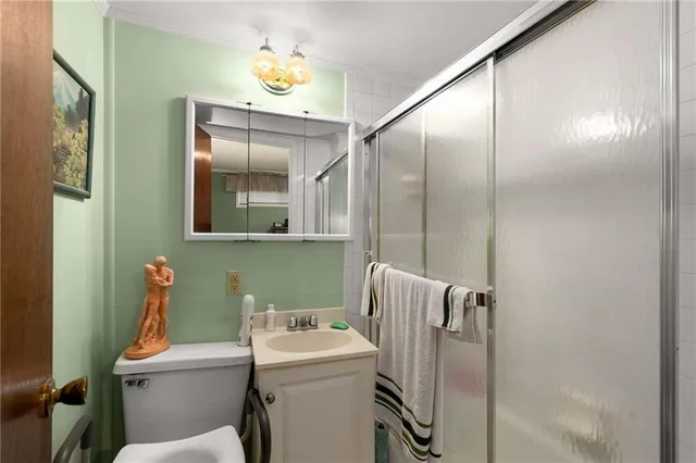 a bathroom with a sink and mirror with toilet
