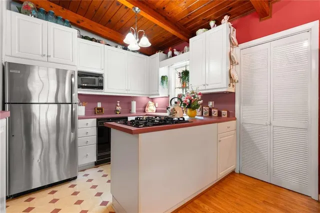 a kitchen with stainless steel appliances granite countertop a refrigerator a stove and a refrigerator
