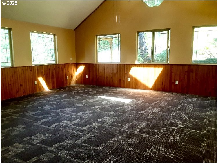 4580 Old House Creek Road Agness, OR 97406 - Photo 12 of 46 a view of an empty room with window and wooden floor