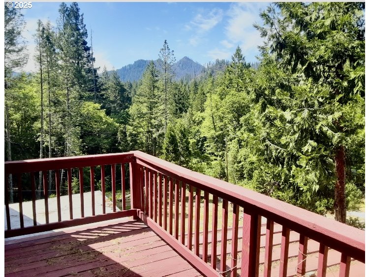 4580 Old House Creek Road Agness, OR 97406 - Photo 20 of 46 a balcony with wooden floor and fence