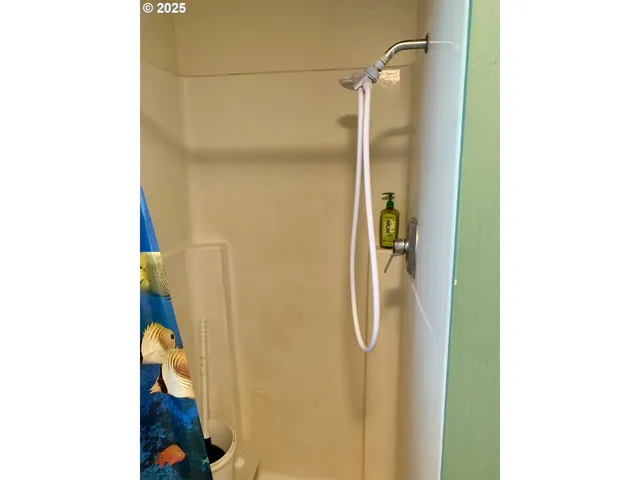 an empty room with wooden floor and cabinet