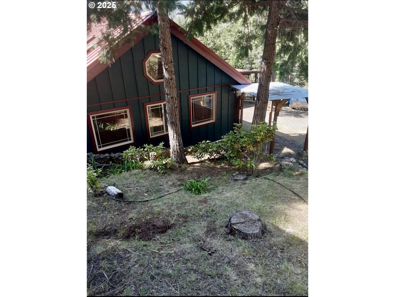 4580 Old House Creek Road Agness, OR 97406 - Photo 5 of 46 a front view of a house with garden