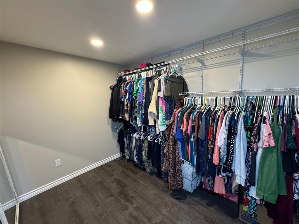 1111 West 7th Street Cisco, TX 76437 - Photo 23 of 33 a view of walk in closet with clothes