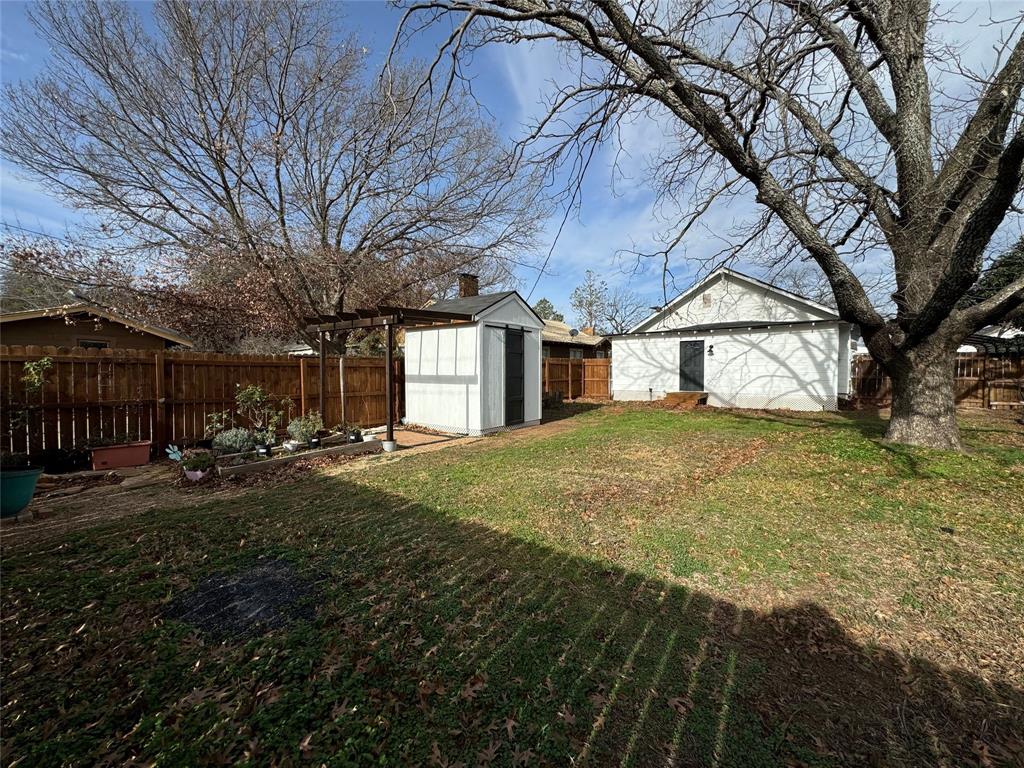 1111 West 7th Street Cisco, TX 76437 - Photo 29 of 33 a view of a house with backyard and sitting area