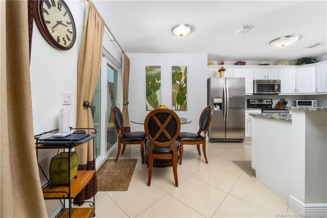 a view of a dining room with furniture and a window