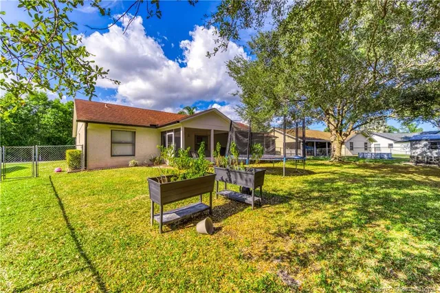 a swimming pool with outdoor seating and yard