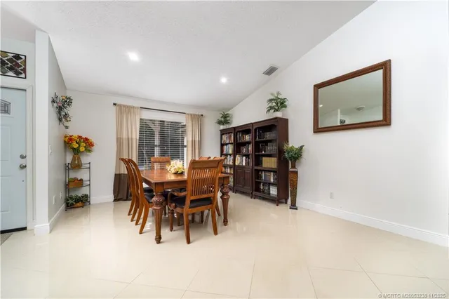 a dining room with furniture and window