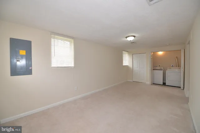 an empty room with windows and closet