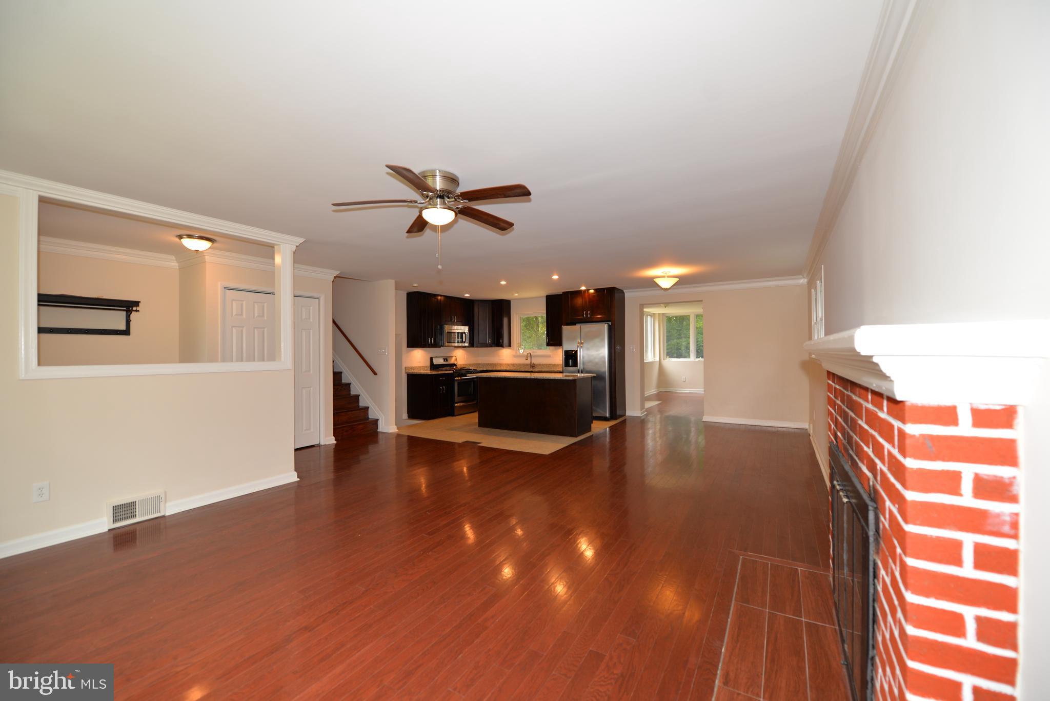 5224 Forman Court Springfield, VA 22151 - Photo 3 of 16 a view of an empty room with kitchen appliances and a ceiling fan