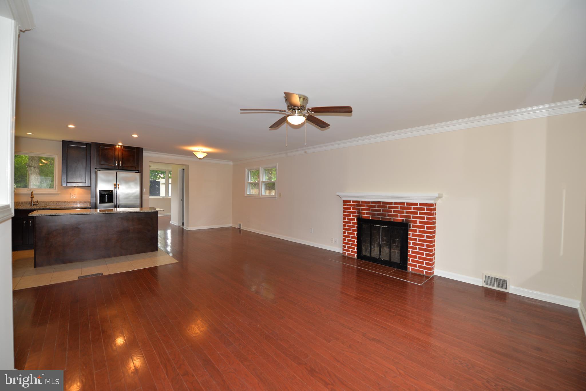 5224 Forman Court Springfield, VA 22151 - Photo 4 of 16 a view of an empty room with a kitchen and wooden floor