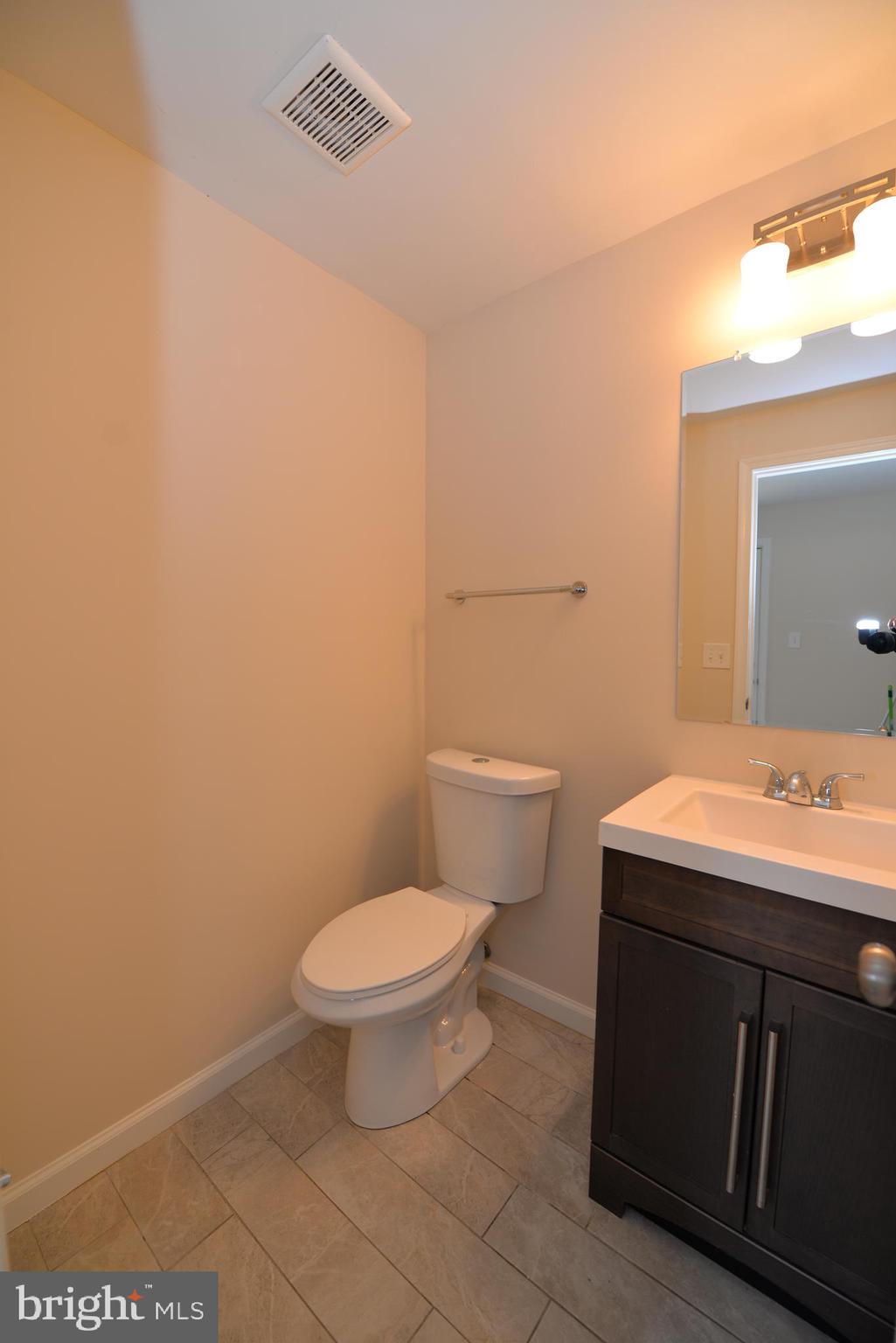 5224 Forman Court Springfield, VA 22151 - Photo 6 of 16 a bathroom with a sink a toilet and mirror