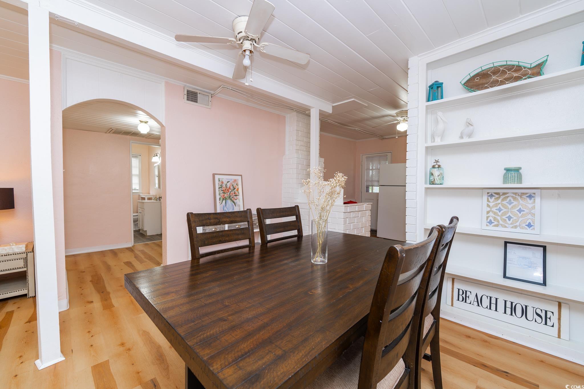 114 North Pinewood Drive Surfside Beach, SC 29575 - Photo 19 of 40 Dining space featuring heating unit, light hardwood / wood-style flooring, ceiling fan, and ornamental molding
