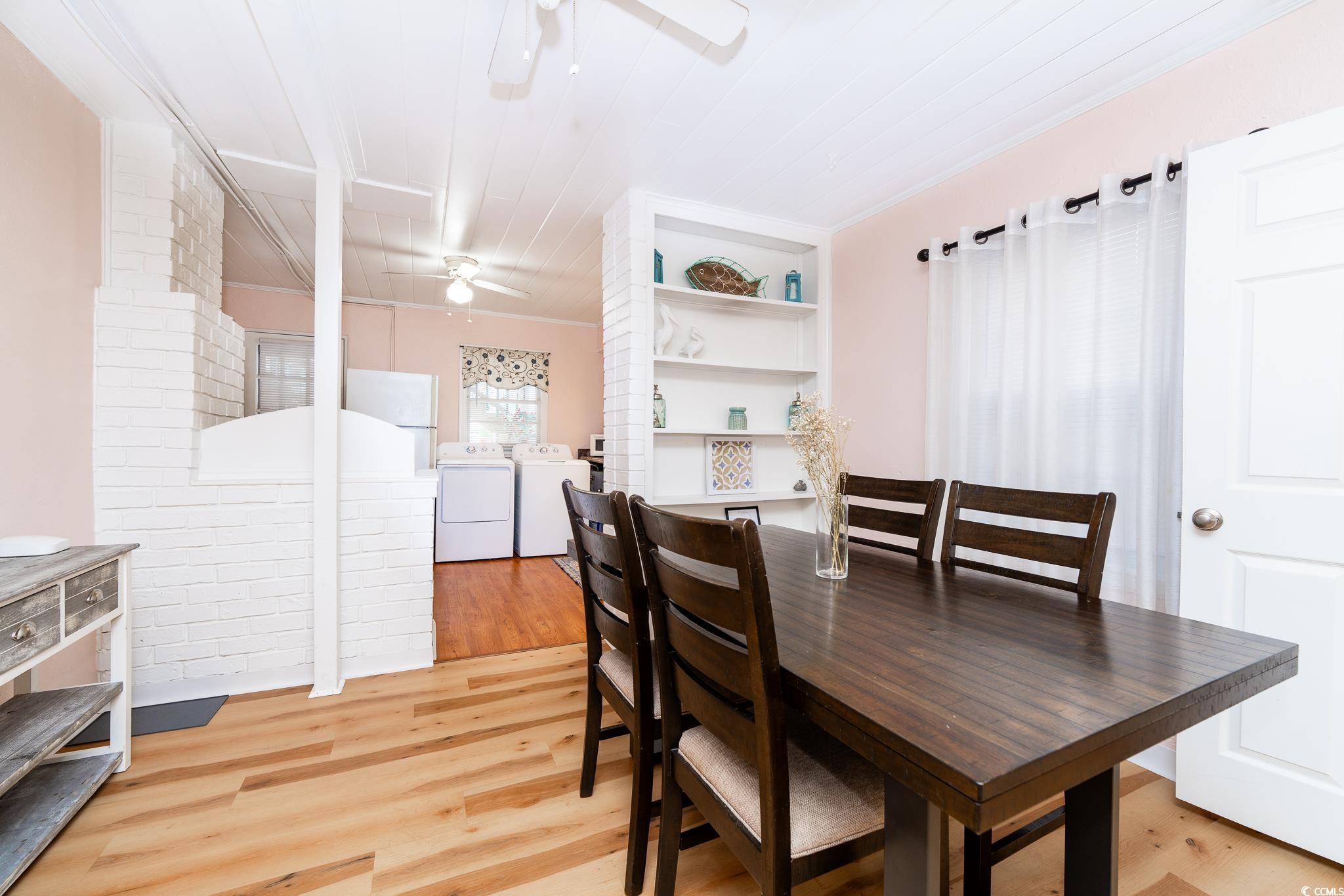 114 North Pinewood Drive Surfside Beach, SC 29575 - Photo 23 of 40 Dining space with washing machine and clothes dryer, ceiling fan, light hardwood / wood-style flooring, and ornamental molding