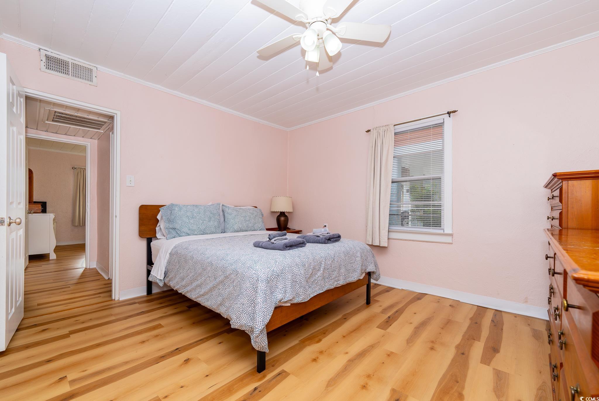 114 North Pinewood Drive Surfside Beach, SC 29575 - Photo 27 of 40 Bedroom with light hardwood / wood-style floors, ceiling fan, and ornamental molding