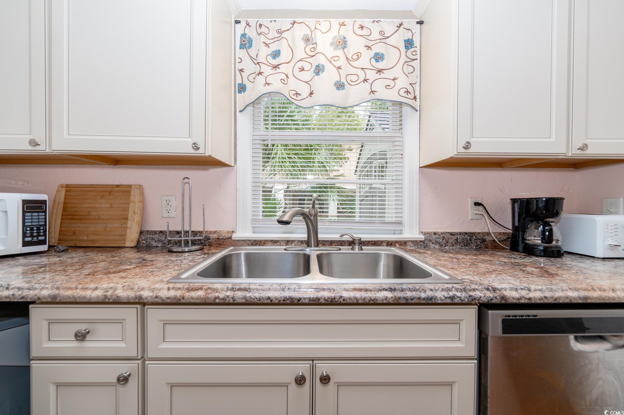 114 North Pinewood Drive Surfside Beach, SC 29575 - Photo 33 of 40 Kitchen with white cabinets, stainless steel dishwasher, and sink