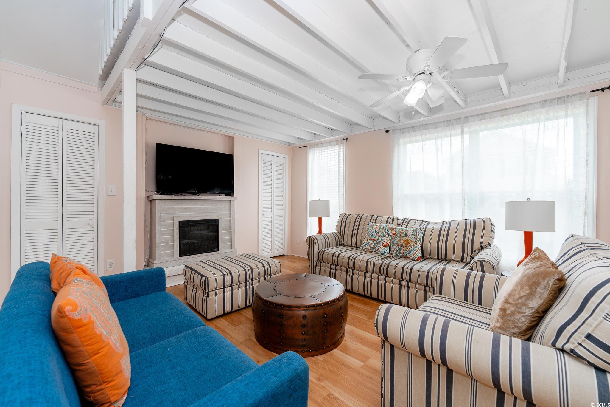 114 North Pinewood Drive Surfside Beach, SC 29575 - Photo 39 of 40 Living room featuring ceiling fan, light hardwood / wood-style flooring, and beamed ceiling