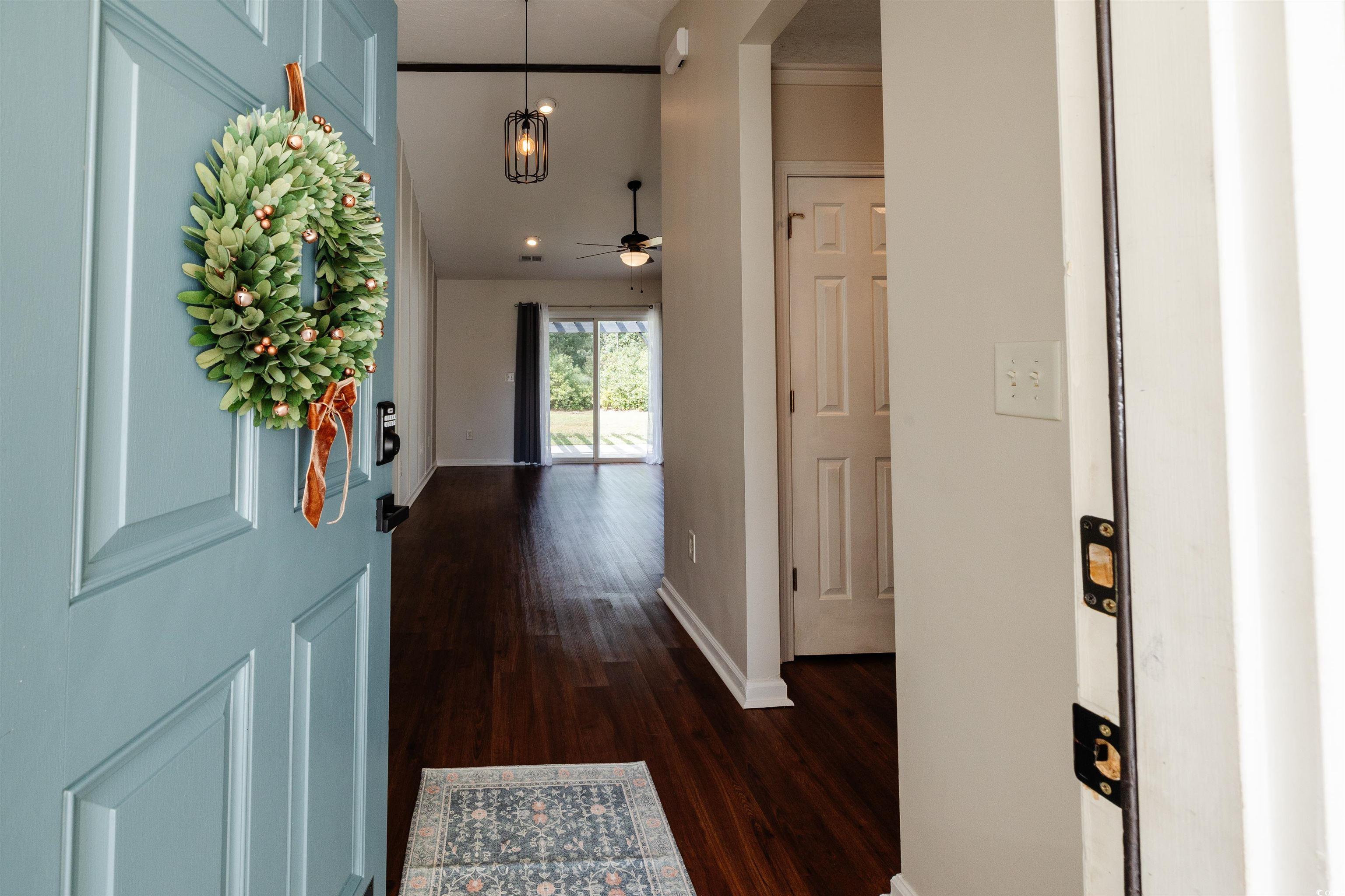 6043 Quinn Road Myrtle Beach, SC 29579 - Photo 3 of 27 Entryway with ceiling fan and dark wood-type floor