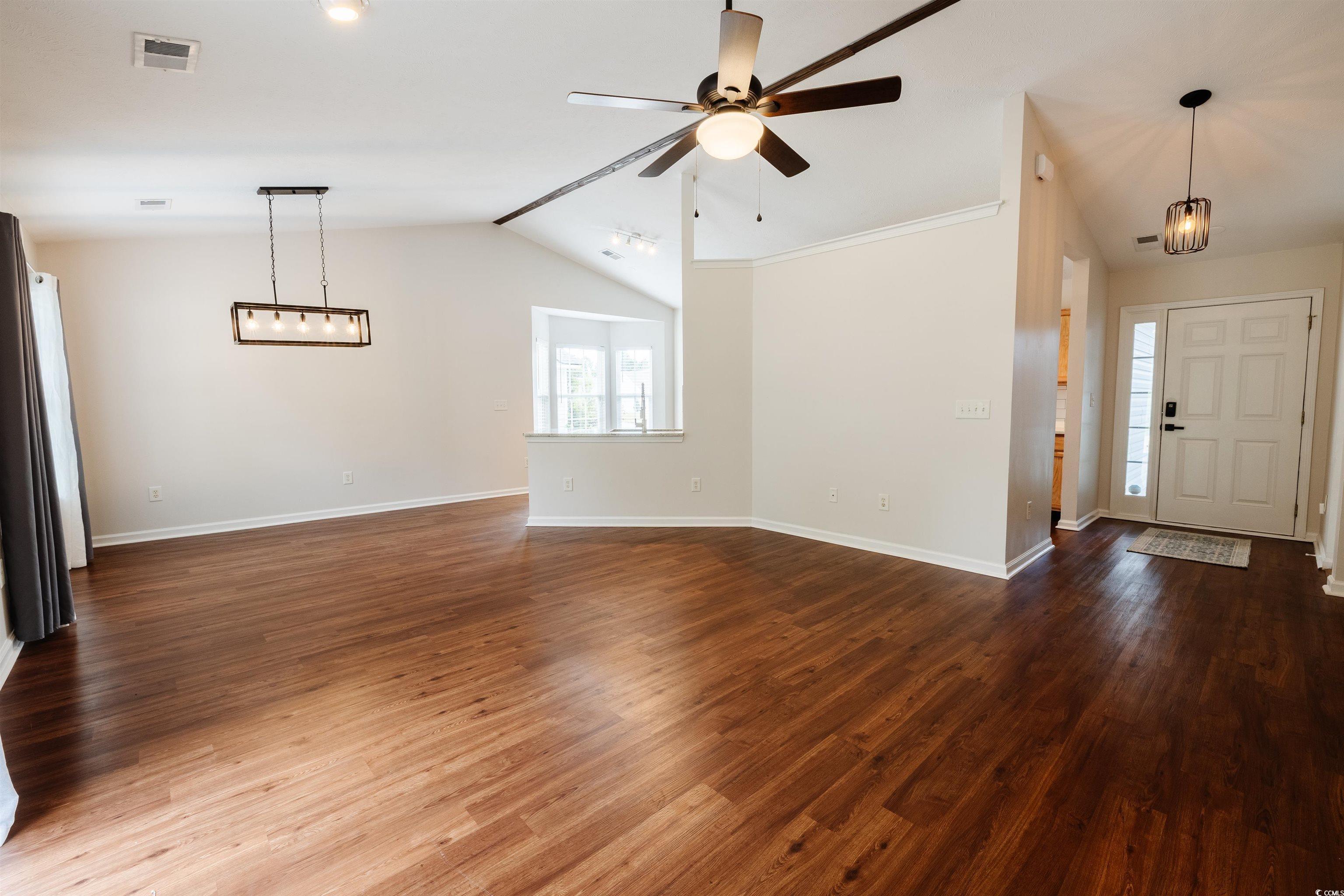 6043 Quinn Road Myrtle Beach, SC 29579 - Photo 7 of 27 Entryway featuring wood-type flooring, vaulted cei