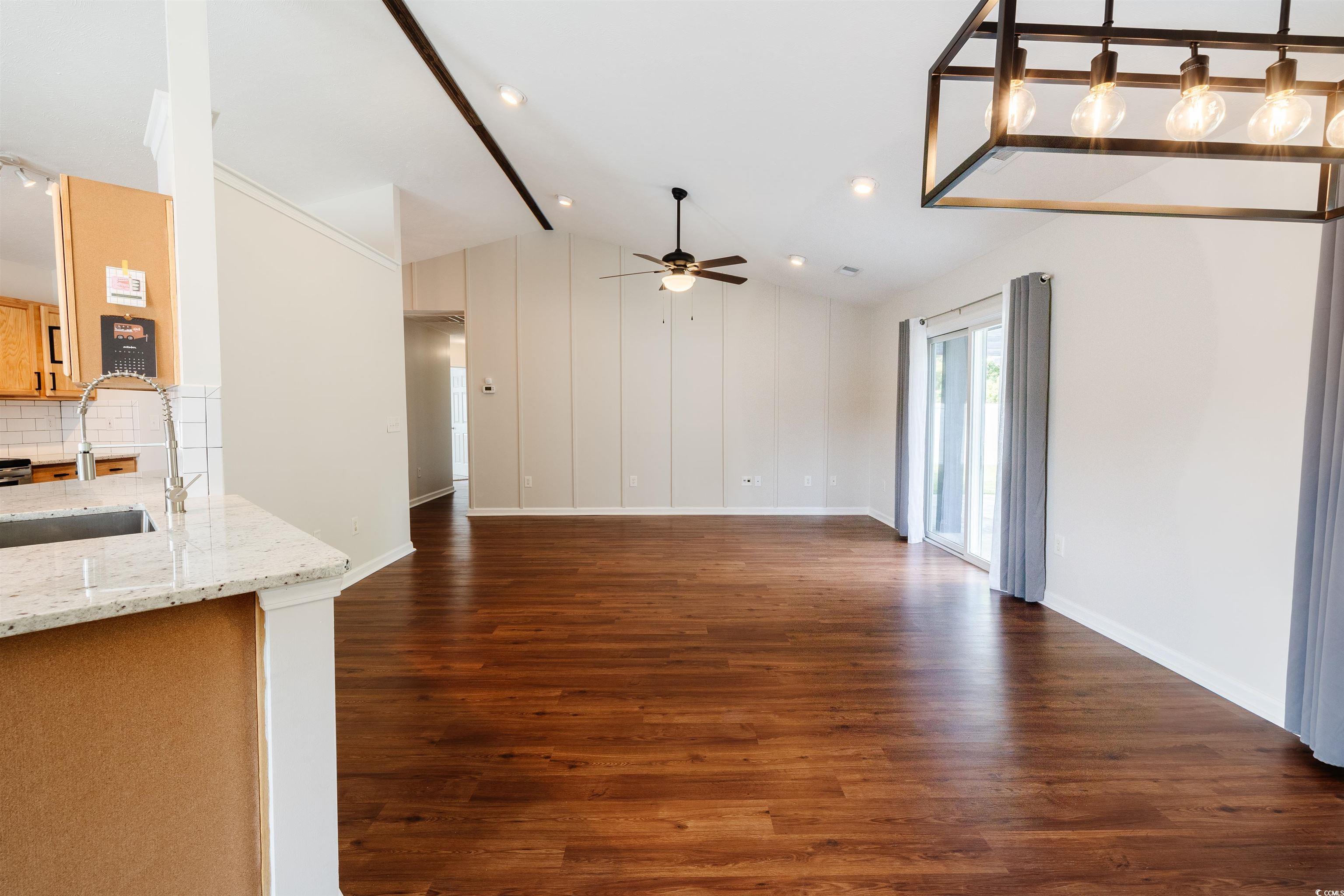 6043 Quinn Road Myrtle Beach, SC 29579 - Photo 9 of 27 Unfurnished living room featuring lofted ceiling,