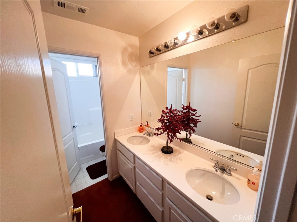 3857 Bella Torre Road Perris, CA 92571 - Photo 13 of 25 a bathroom with a sink and a mirror