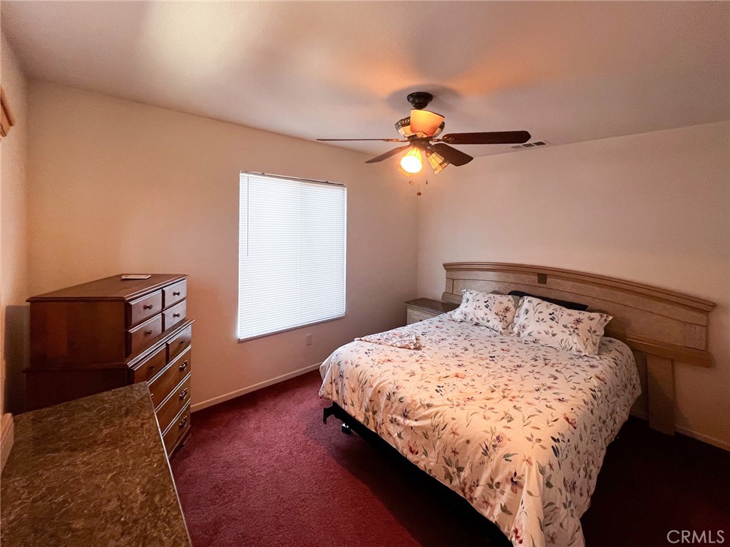 3857 Bella Torre Road Perris, CA 92571 - Photo 14 of 25 a bedroom with a bed and a window