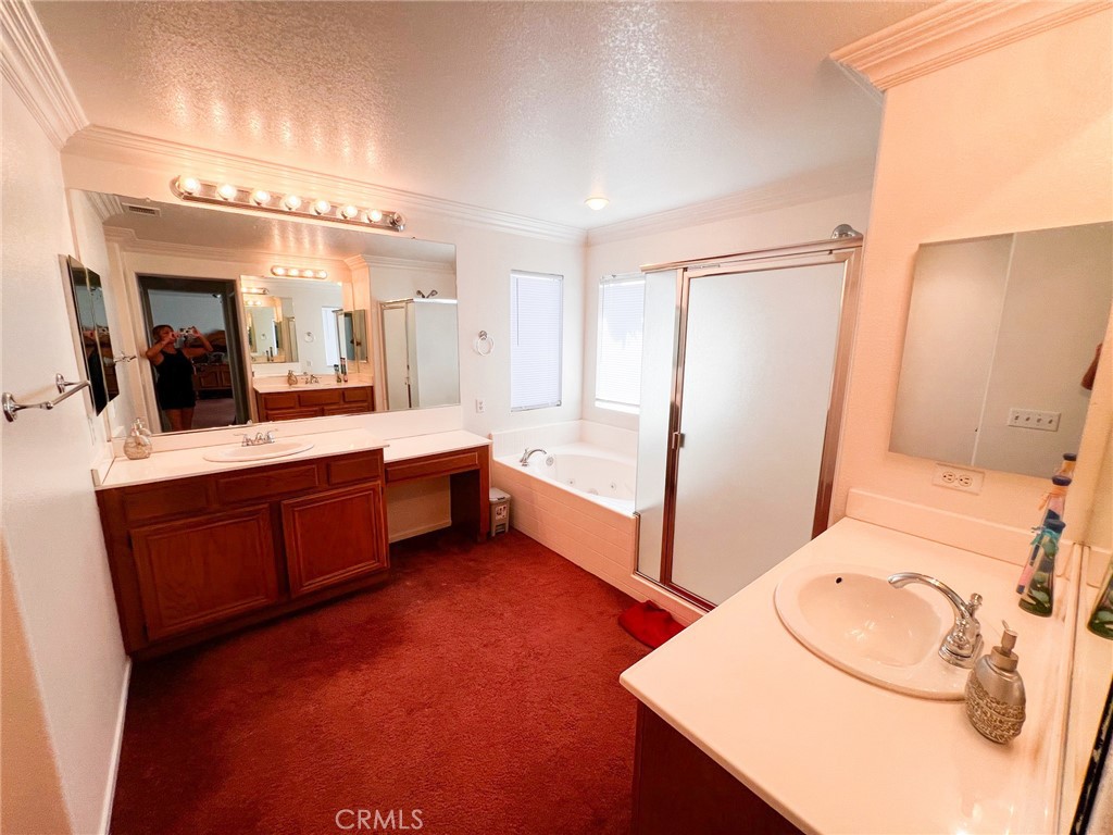 3857 Bella Torre Road Perris, CA 92571 - Photo 17 of 25 a bathroom with a double vanity sink mirror and bathtub
